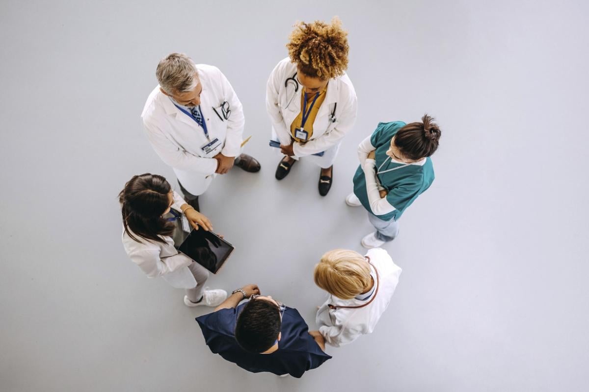 Healthcare team stands in a circle