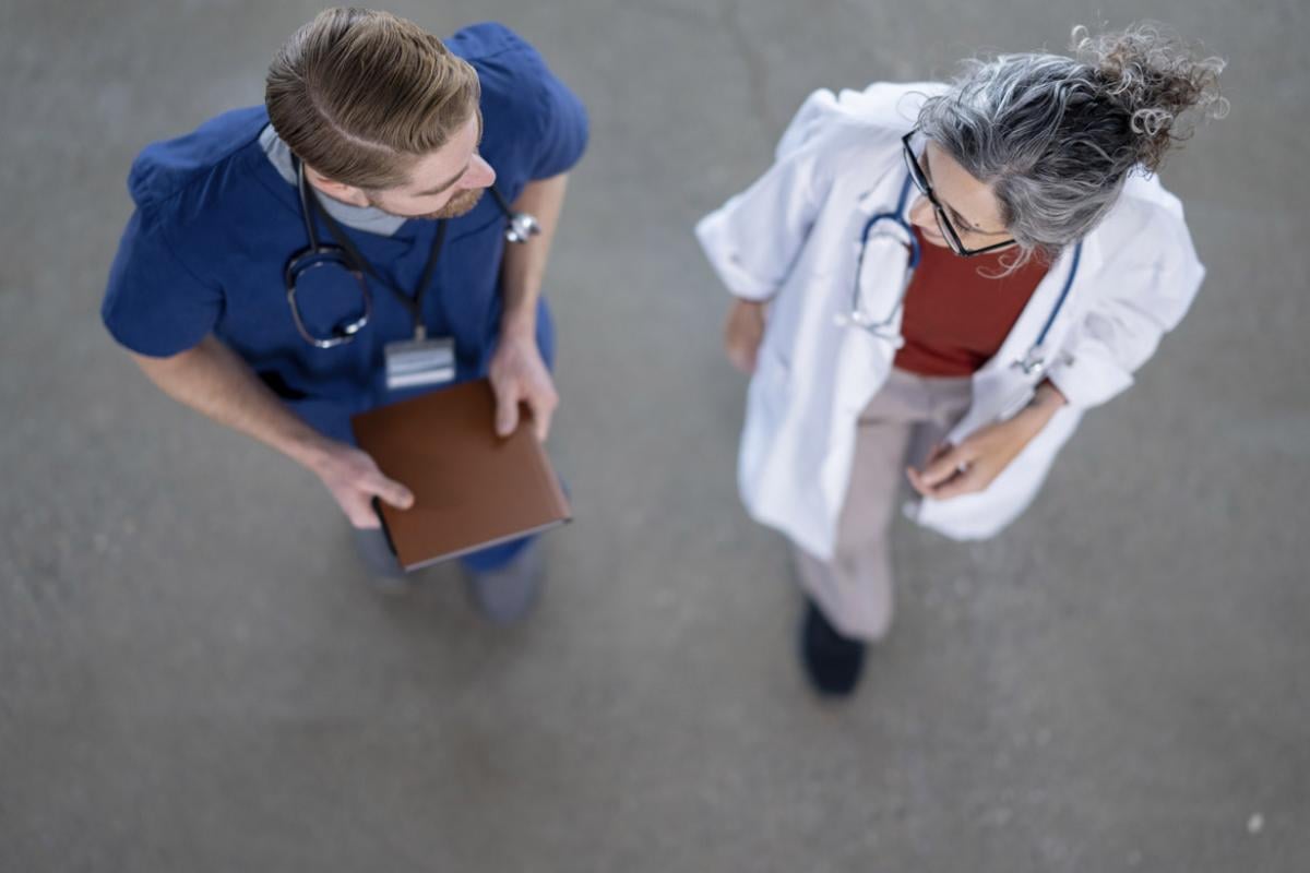 Two healthcare workers in conversation