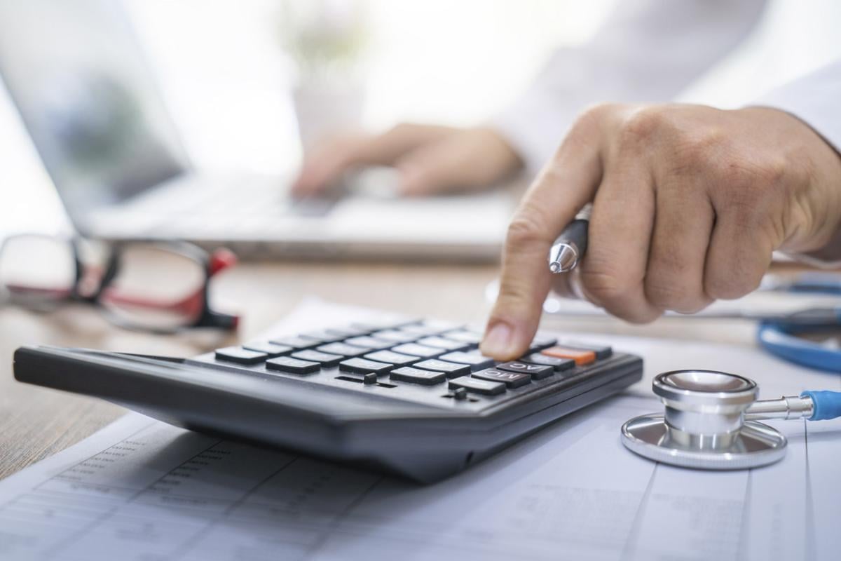 Physician uses a calculator
