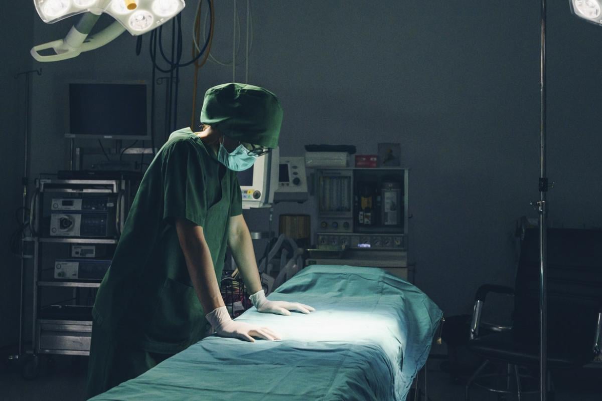 Healthcare worker in empty hospital operating room