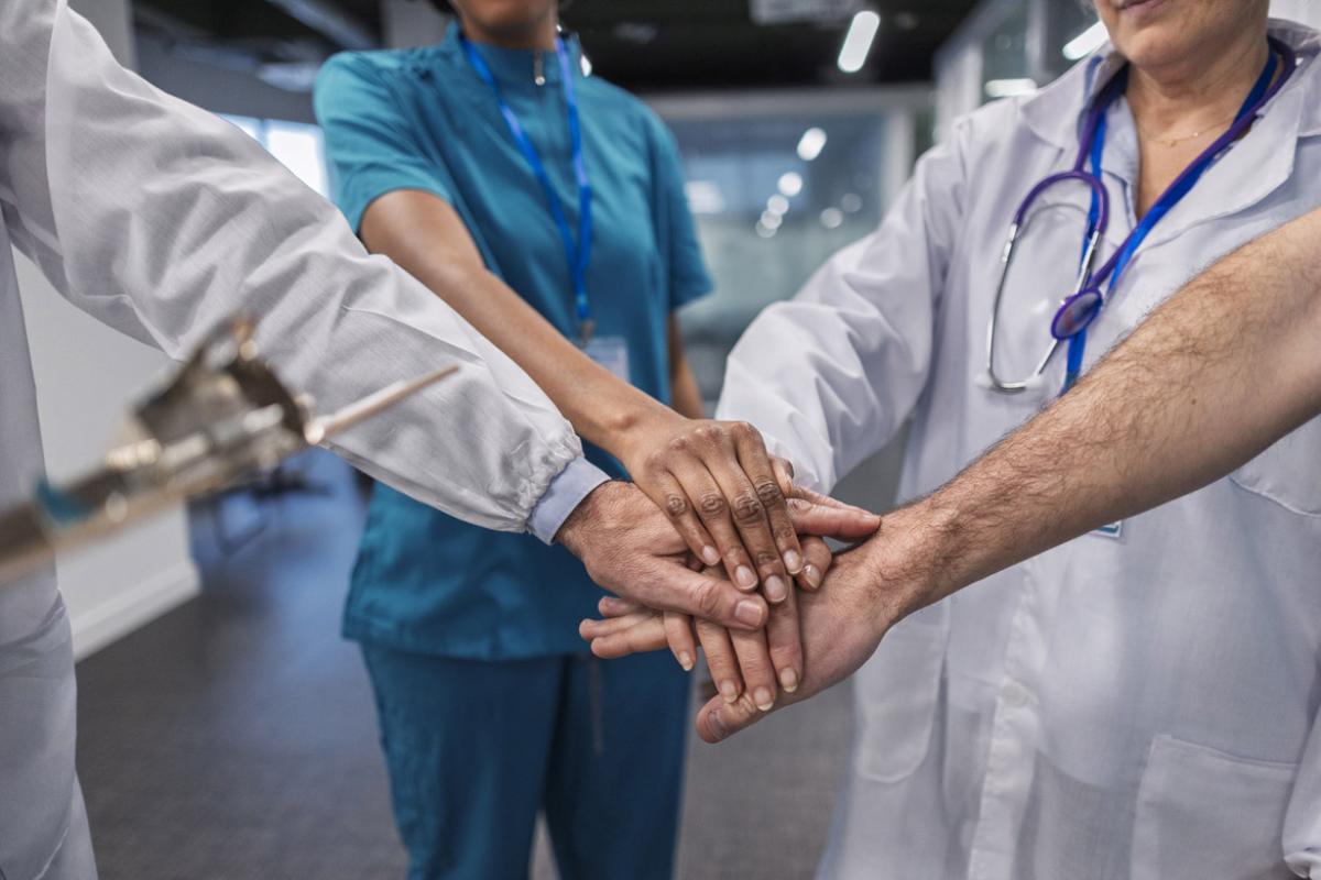 Medical team stacking hands