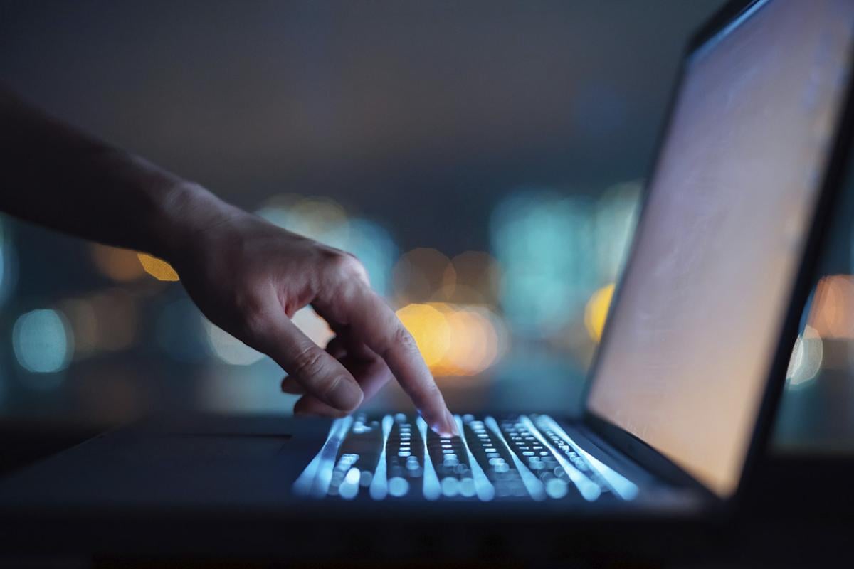 Hand points to laptop