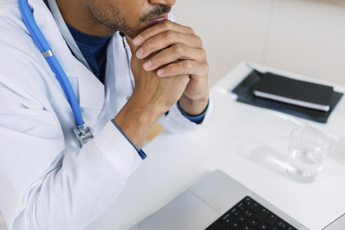 Physician sits at desk