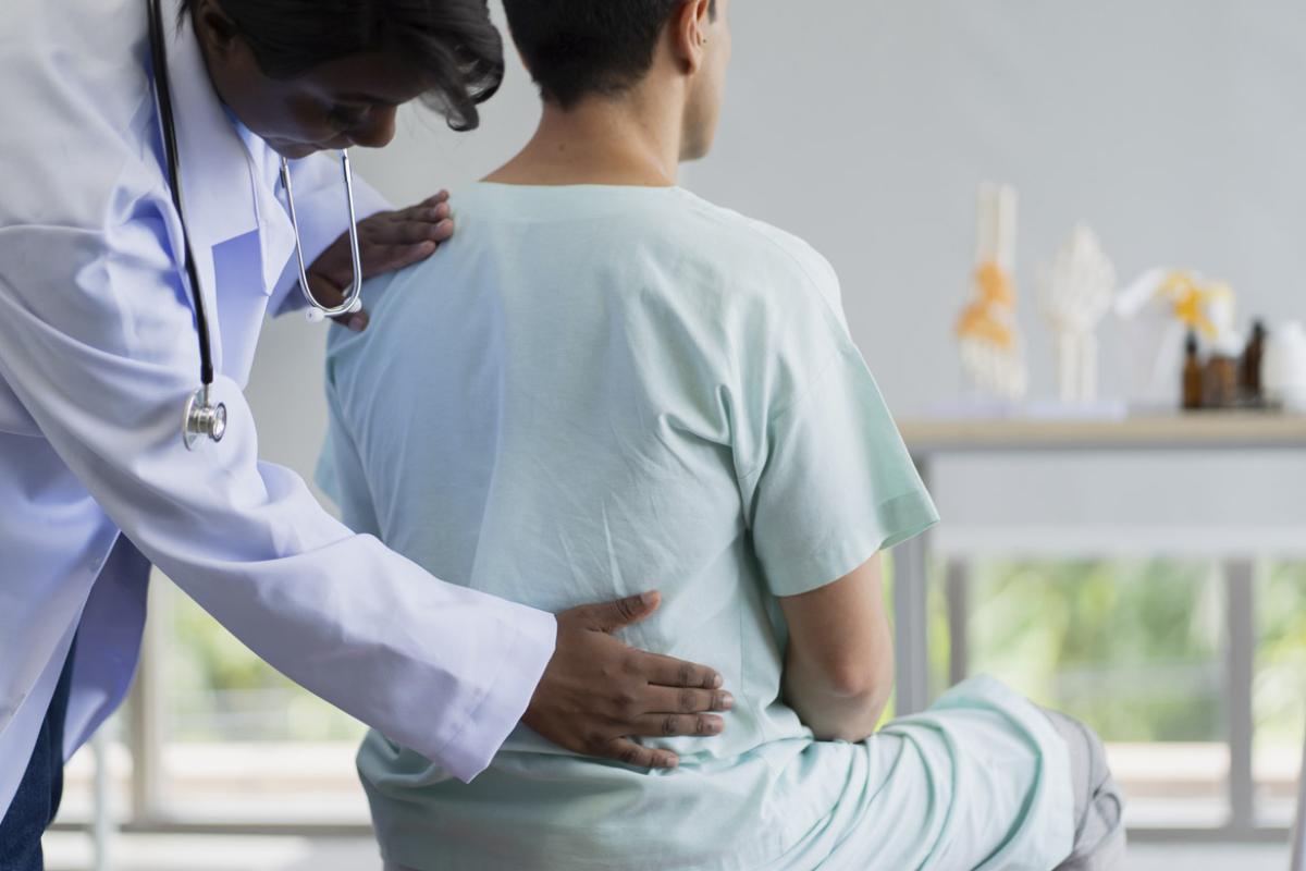 Physiotherapist assists patient