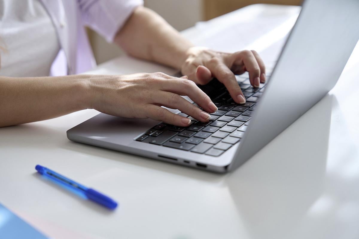 Hands on a laptop