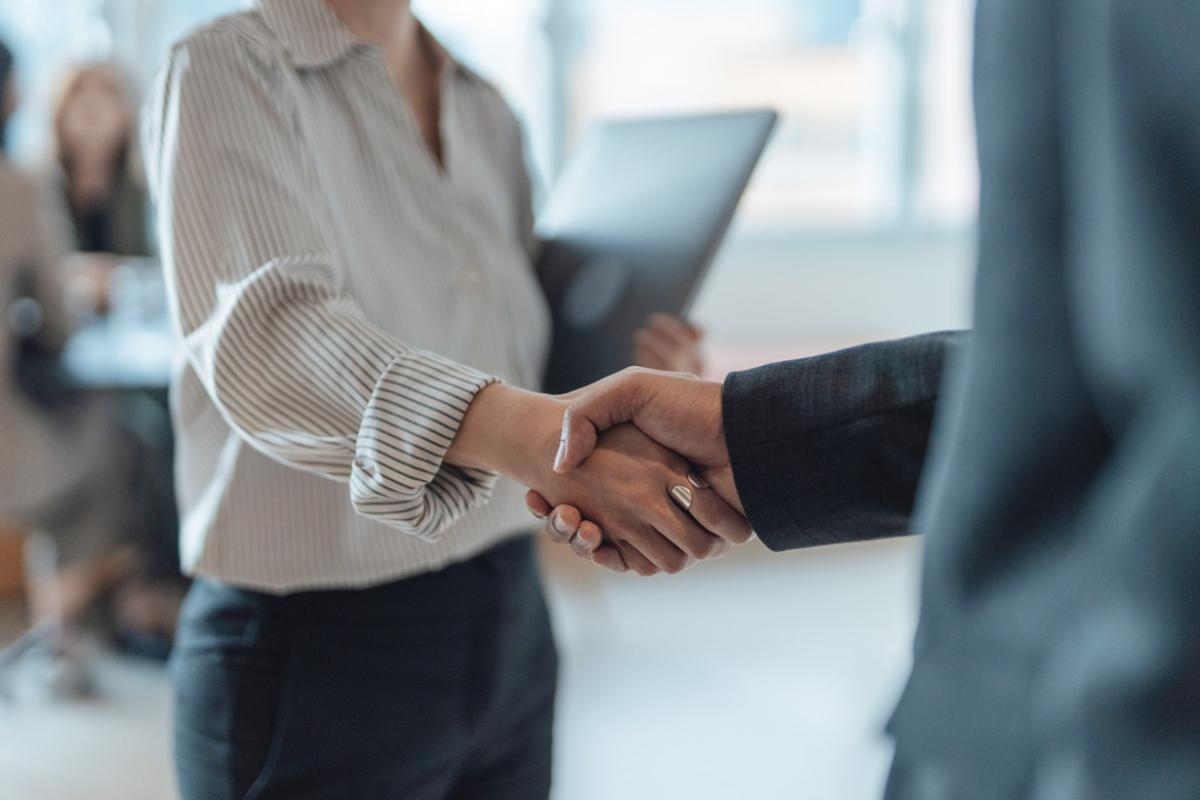 Two people shake hands