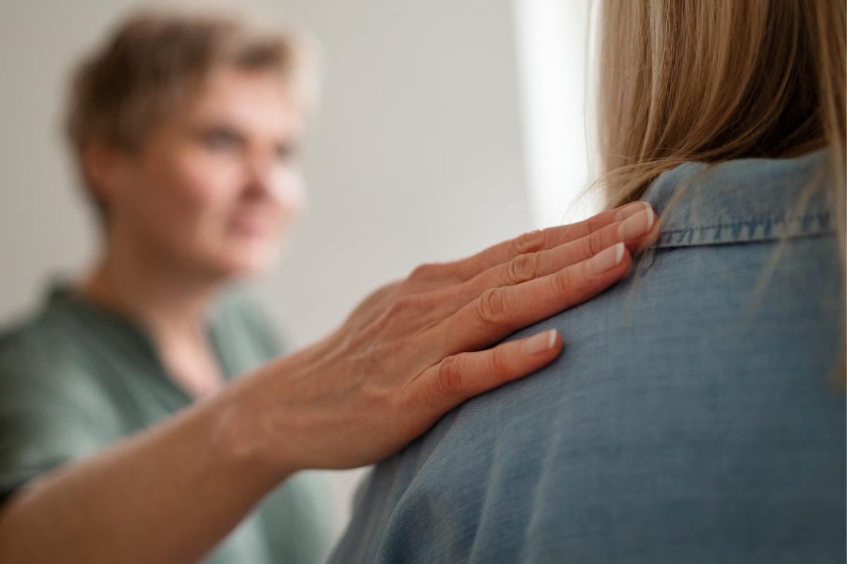 Reassuring hand on shoulder