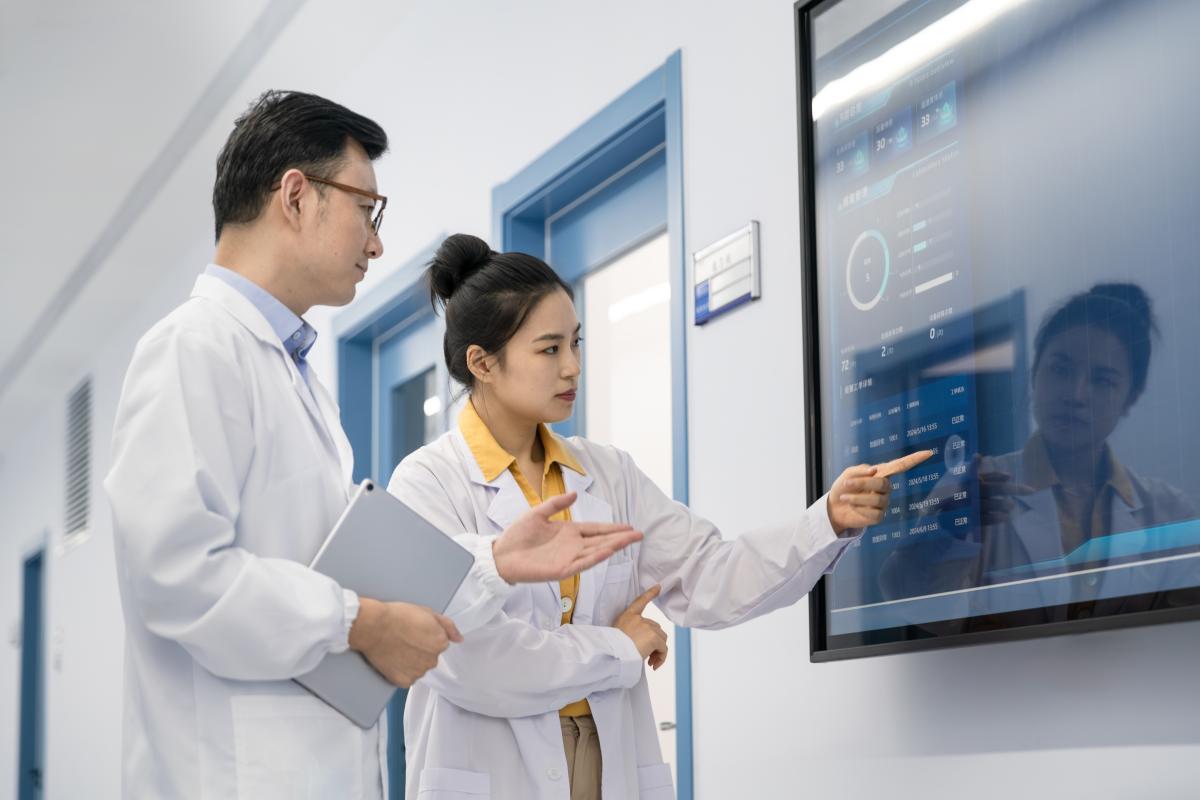 Doctors look at data on a large screen
