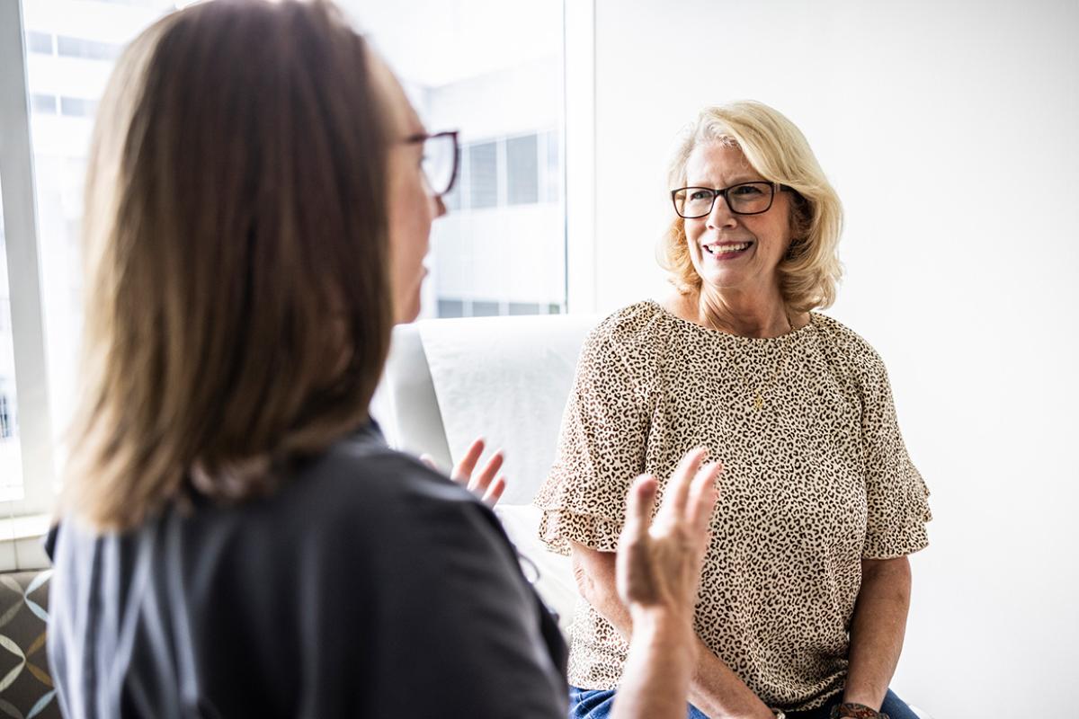 Smiling patient listens to doctor