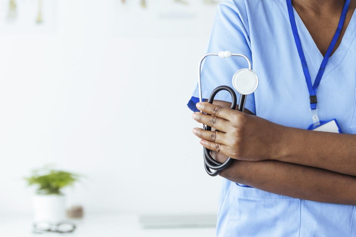 Physician holds stethoscope