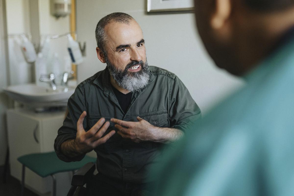 Patient speaks with healthcare worker