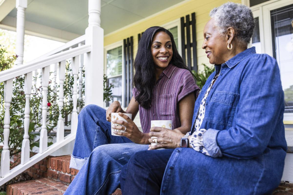 Two people sit on front steps