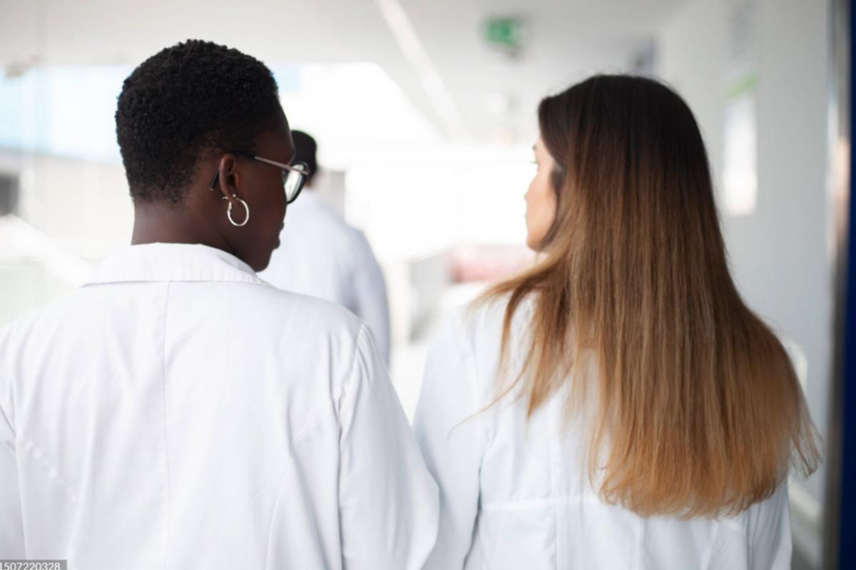 Two healthcare workers in conversation