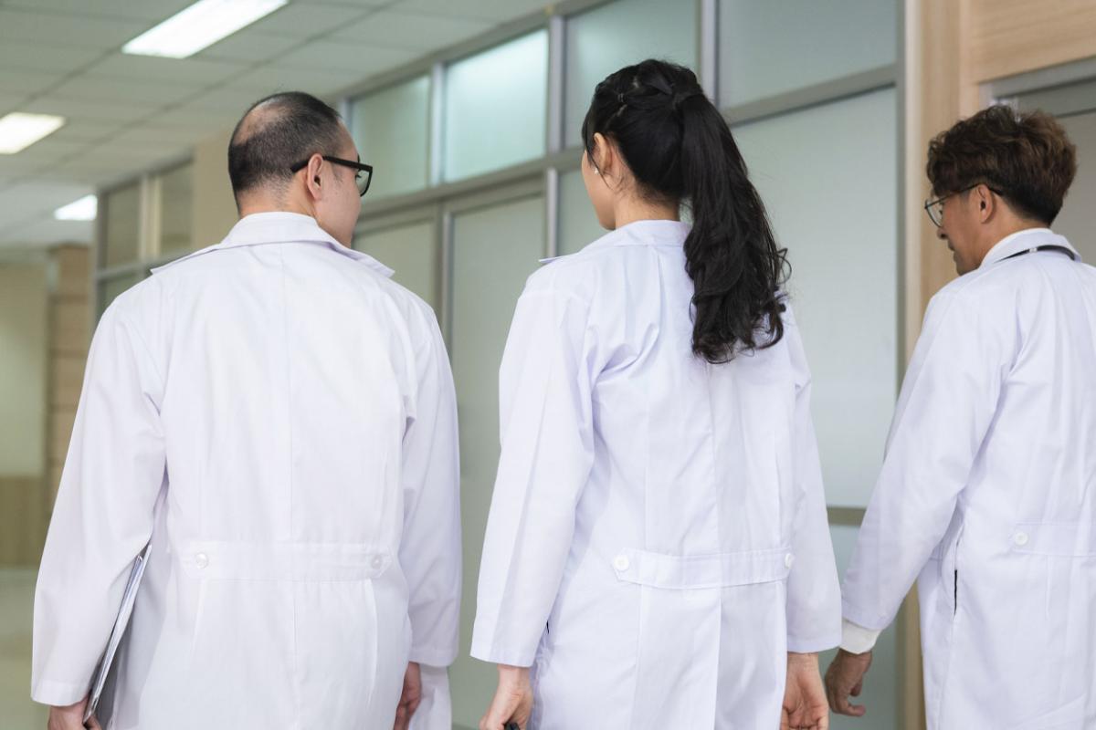 Three physicians in a hallway