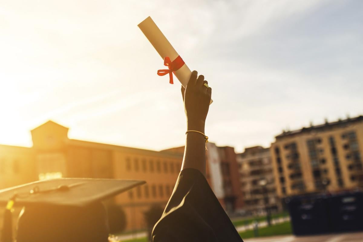 Hand holds a diploma