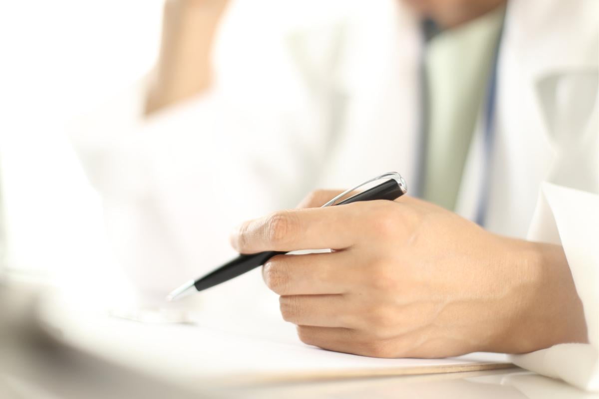 Hand holds a pen