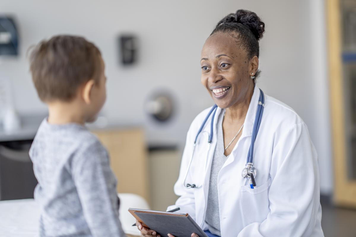 Physician talking with small child