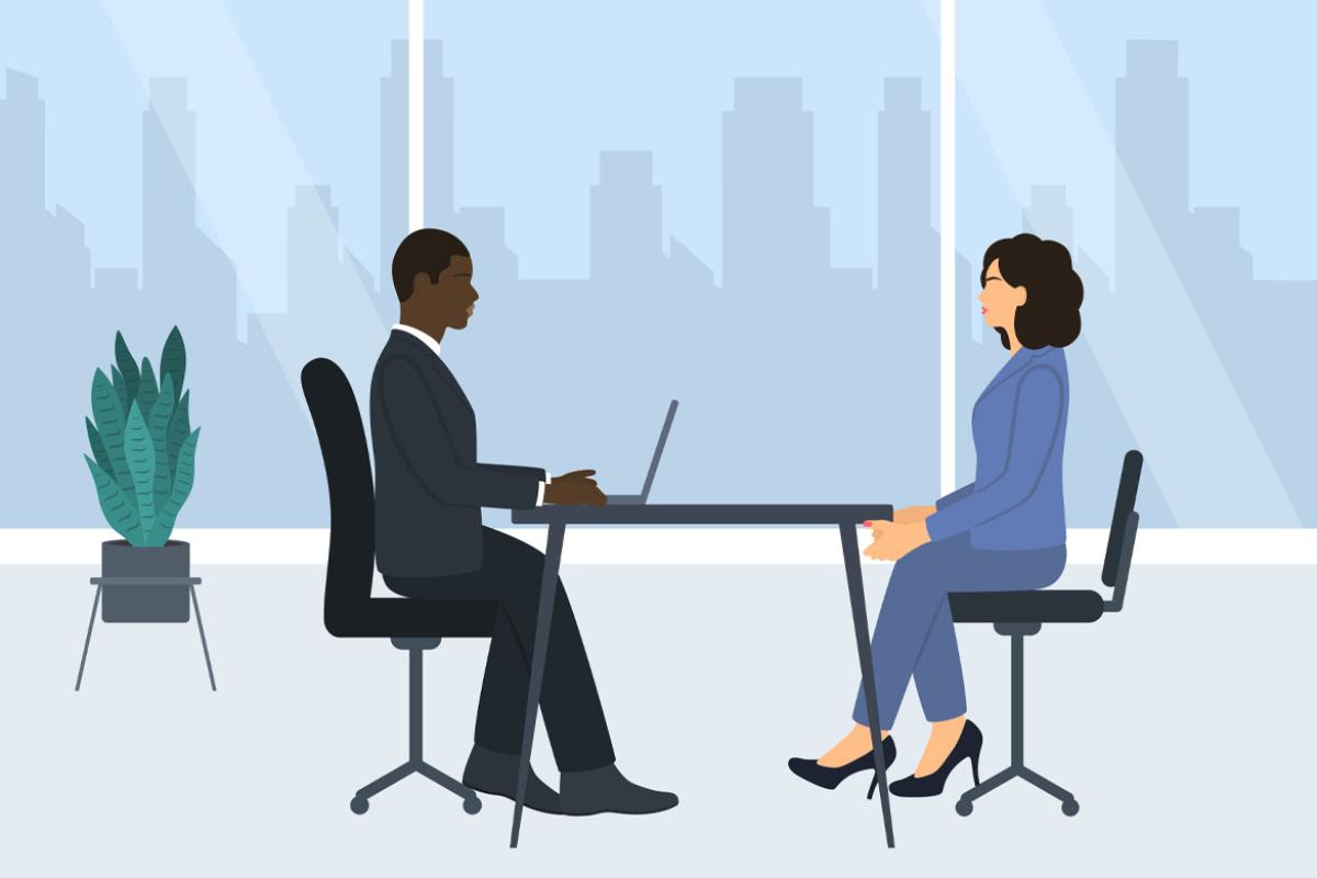 Two businesspeople at a table in an office