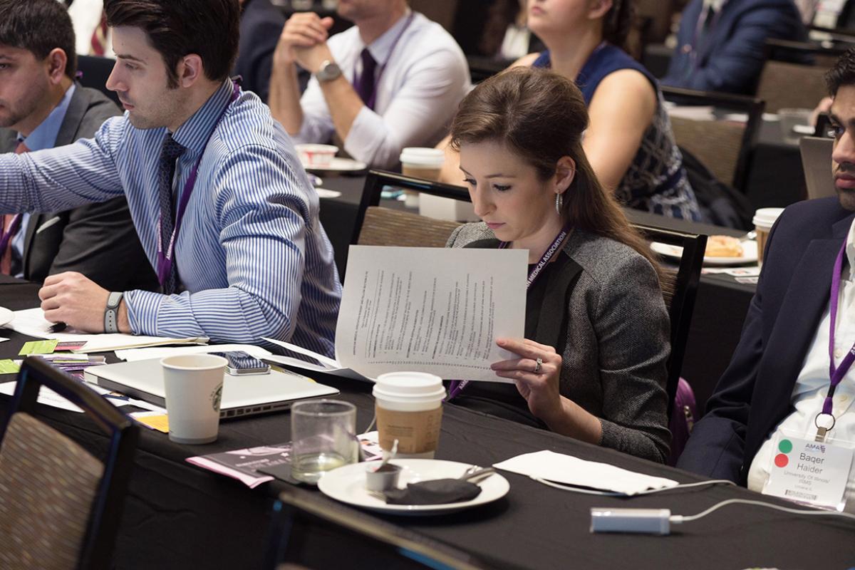 A resident reads a handout during the HOD Annual Meeting.