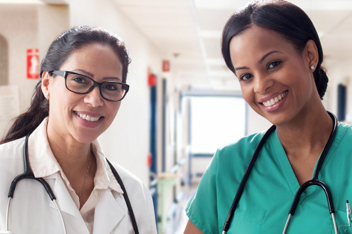 Portrait of 2 smiling women physicians.