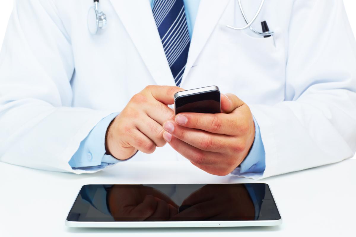 Physician holding a cell phone. 