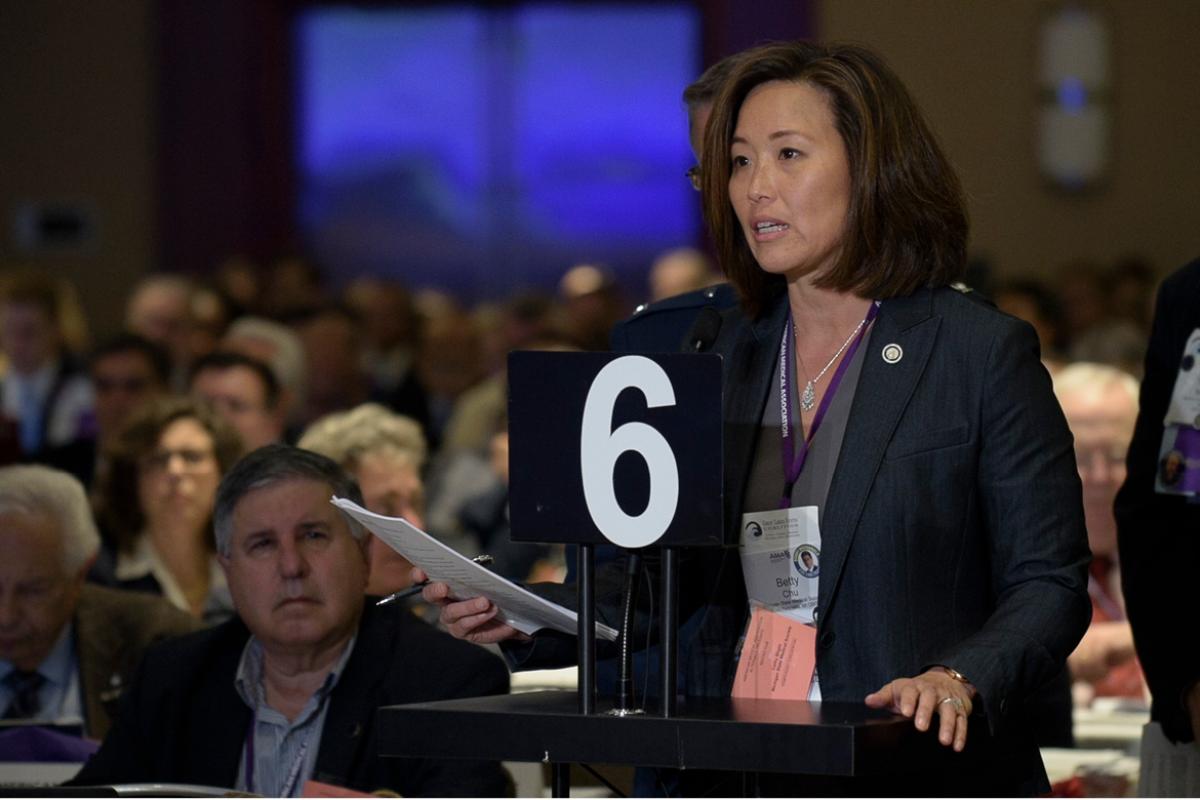 HOD Delegate speaks to crowd at meeting. 