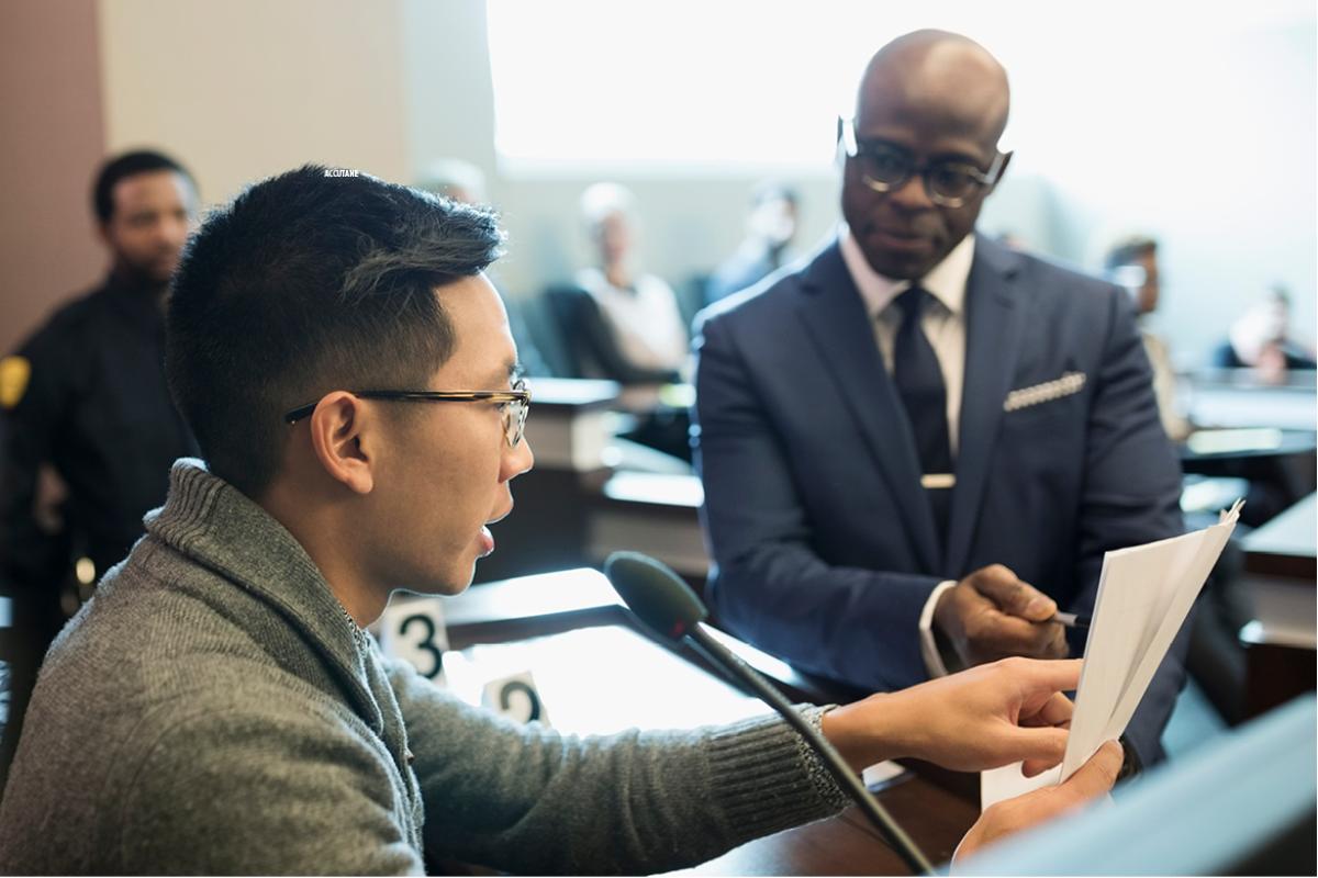Court witness on the stand being questioned.
