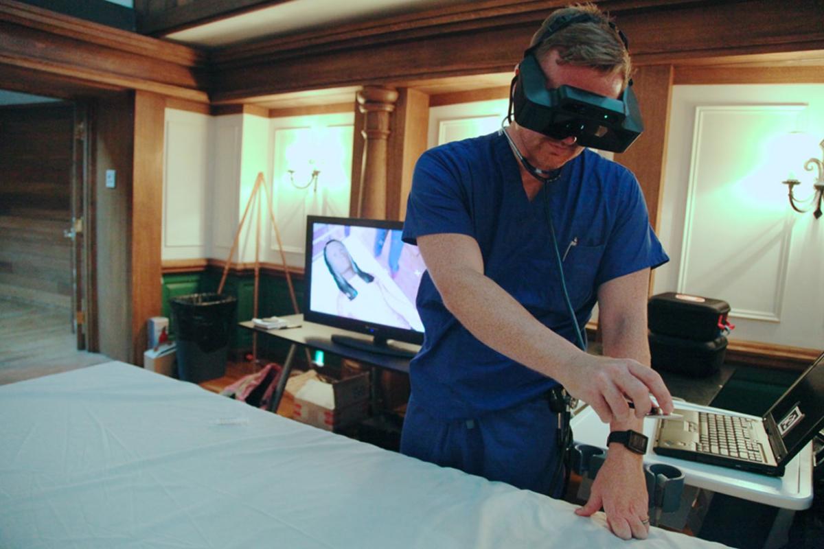 Doctor using a virtual reality patient simulator.