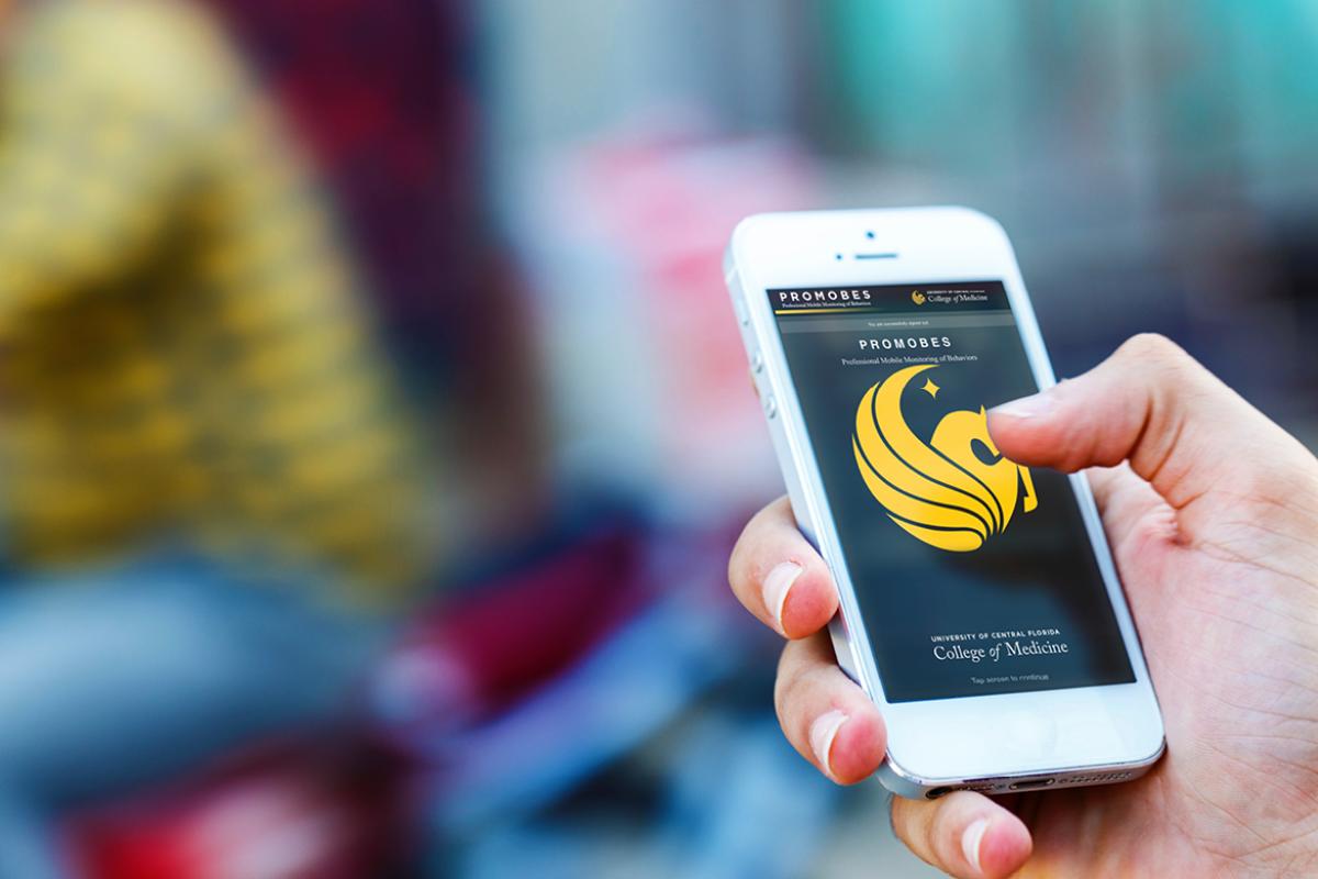 Hand holding cell phone, using an app