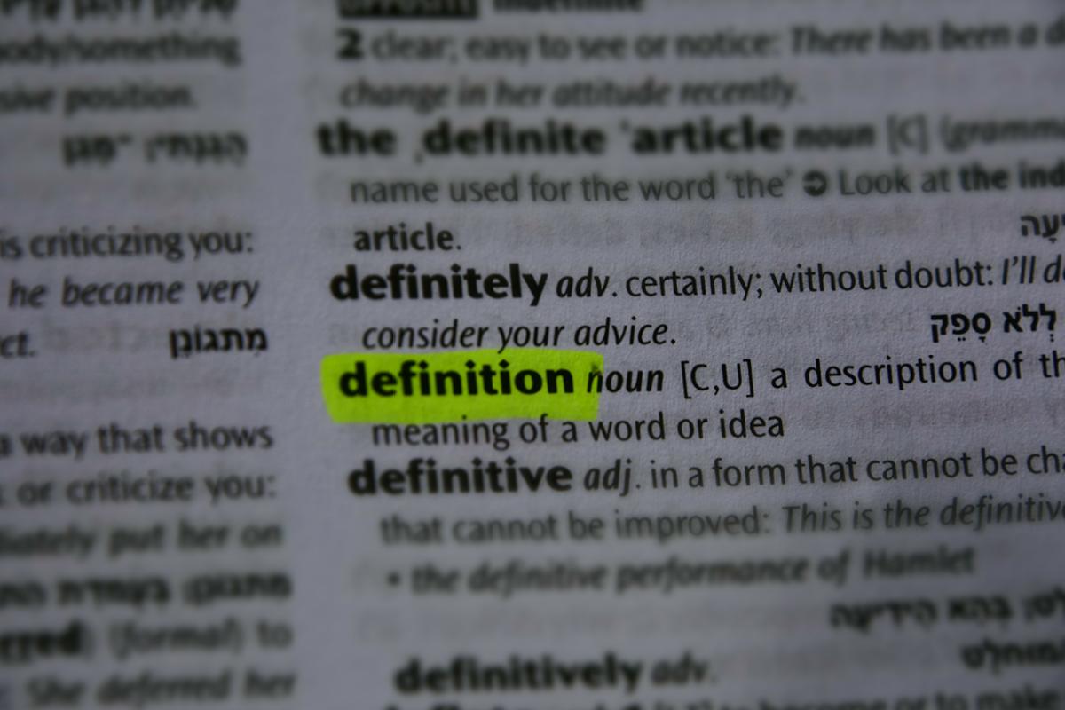 The word 'definition' highlighted on a dictionary page.