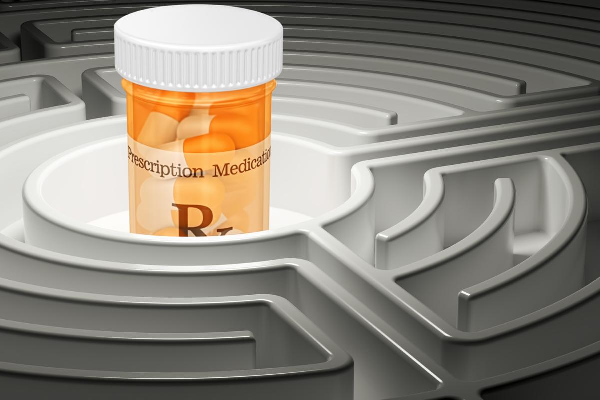 A large prescription pill bottle sits in the center of a maze. 