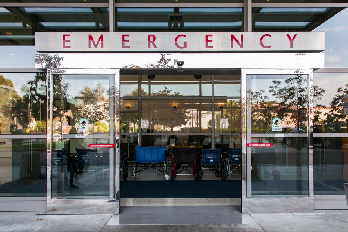The entrance to an emergency room with four wheelchairs sitting inside the door.