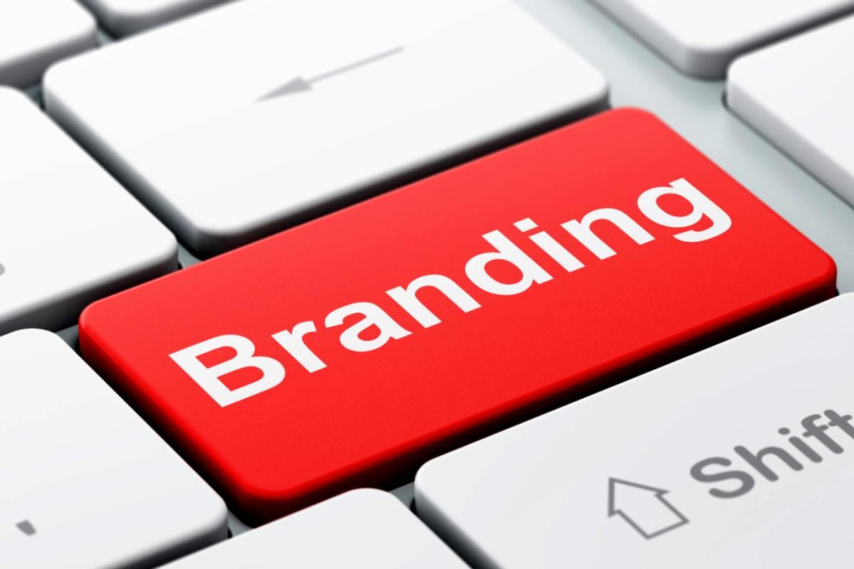 A computer keyboard with the enter button replaced with a red button that says branding.