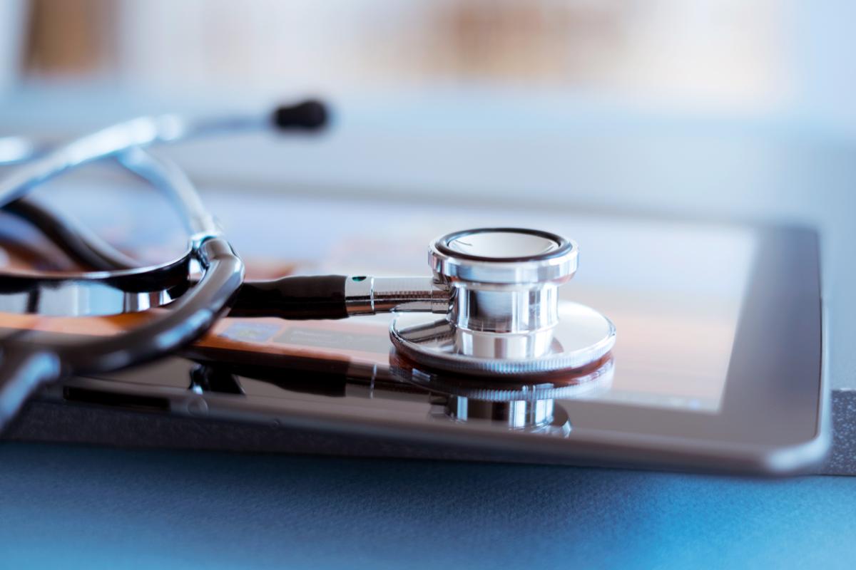 Closeup of stethoscope and tablet.