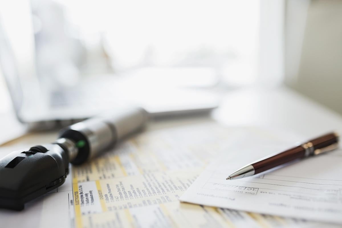 Closeup of pen, prescription, and medical device.
