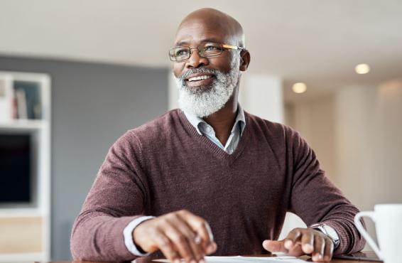Man sitting at desk smiling