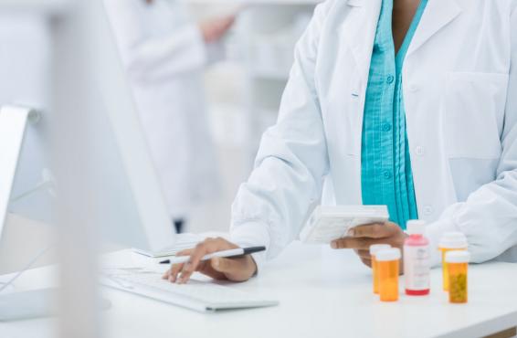 Physician working on an opioid prescription on the computer.