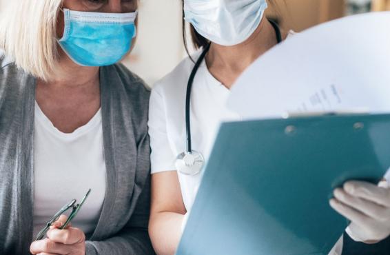 Two people looking at a clipboard
