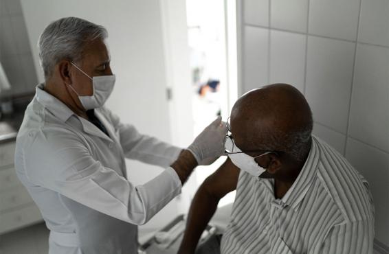 Physician administering vaccine to patient