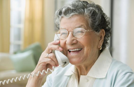 Smiling person speaking on the phone