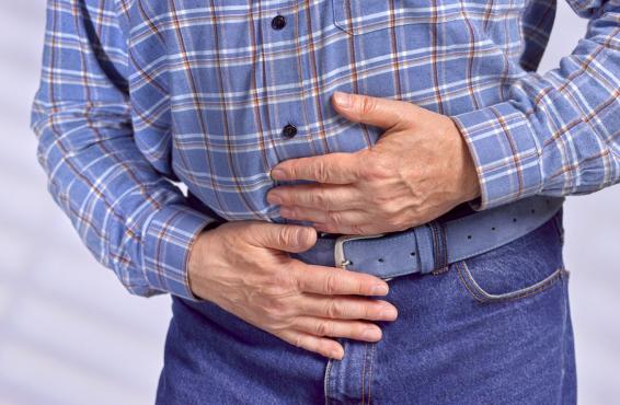 A man clutching his stomach.