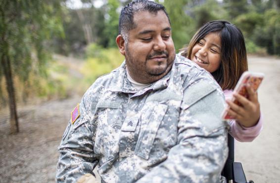 Smiling child showing a parent their smartphone