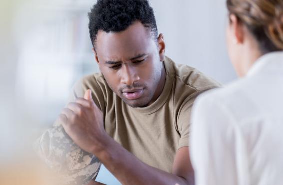 Military veteran speaking with another individual