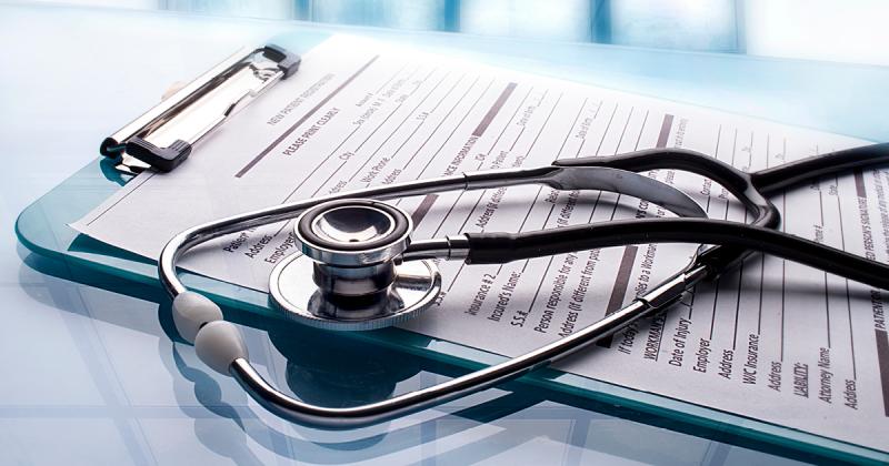 Stethoscope sitting on a clipboard with form attached