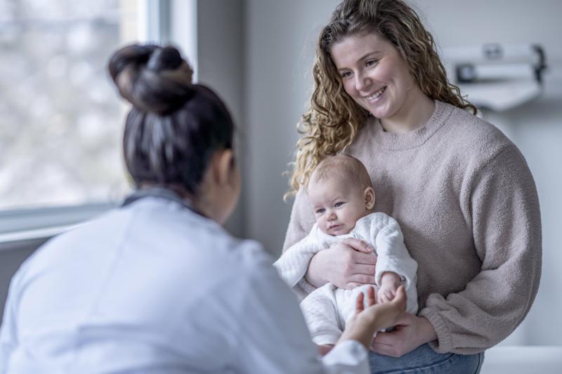 Baby holding a doctor's finger