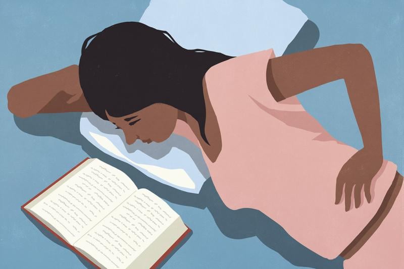 Reclining figure reading in bed