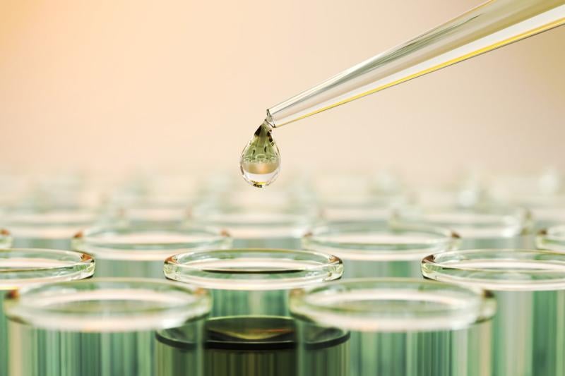 Testing liquid from pipette into test tubes