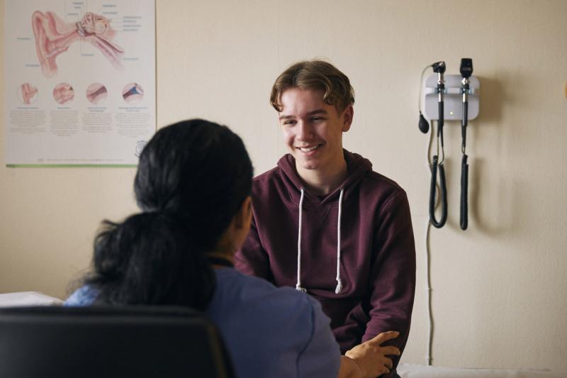 Smiling teenage patient in doctor's office