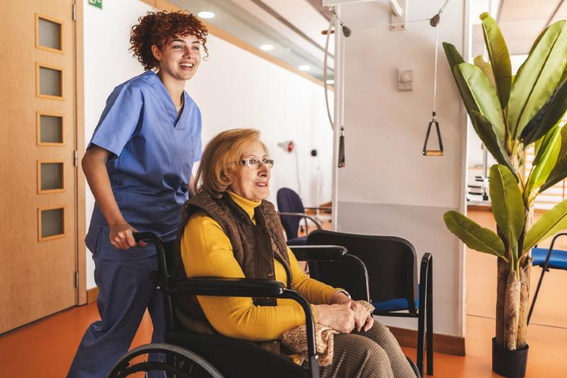 Healthcare worker and patient in wheelchair