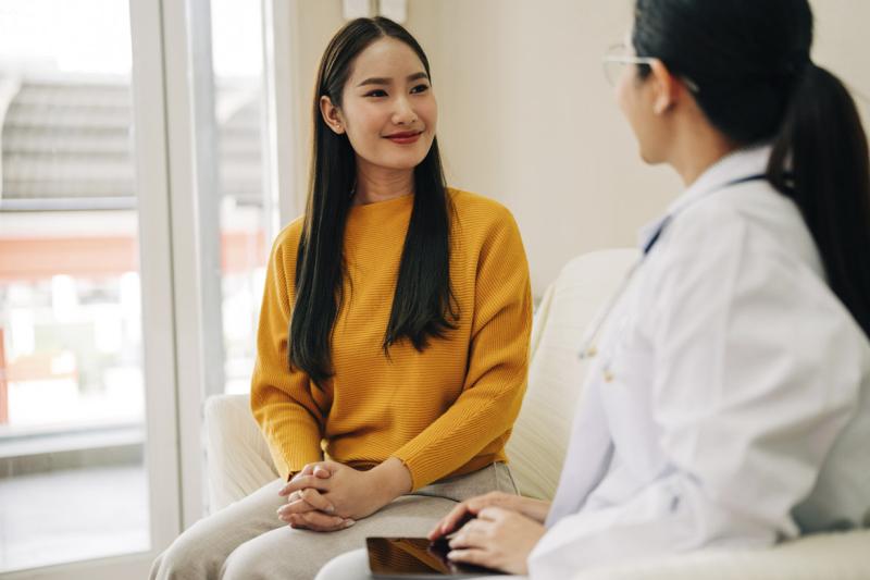 Smiling patient looks at physician during appointment